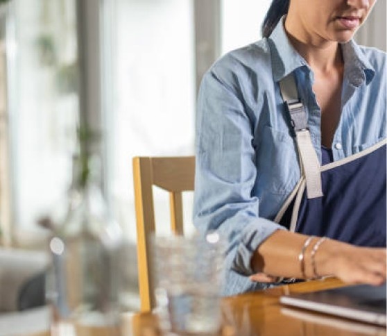 Working with a Sling Person working on a laptop while wearing a sling.